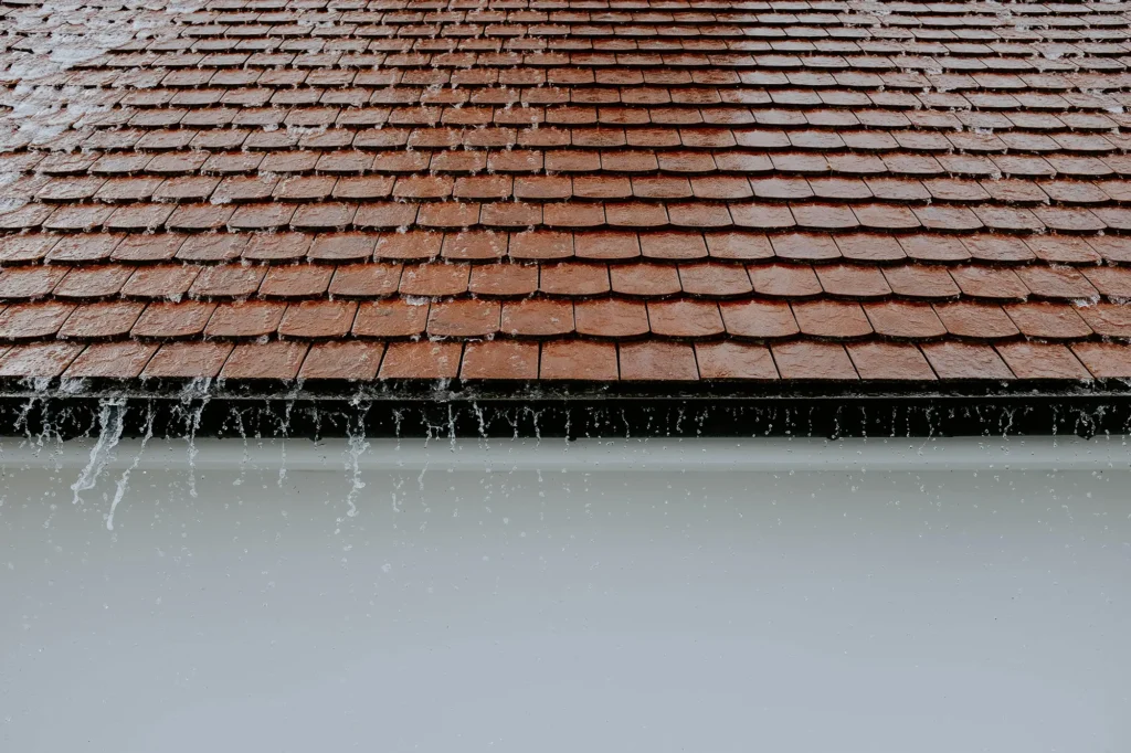 rain falling from roof of home