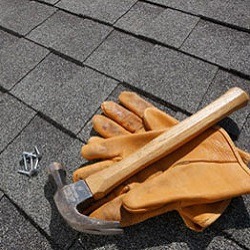 roof repairs with gloves and hammer
